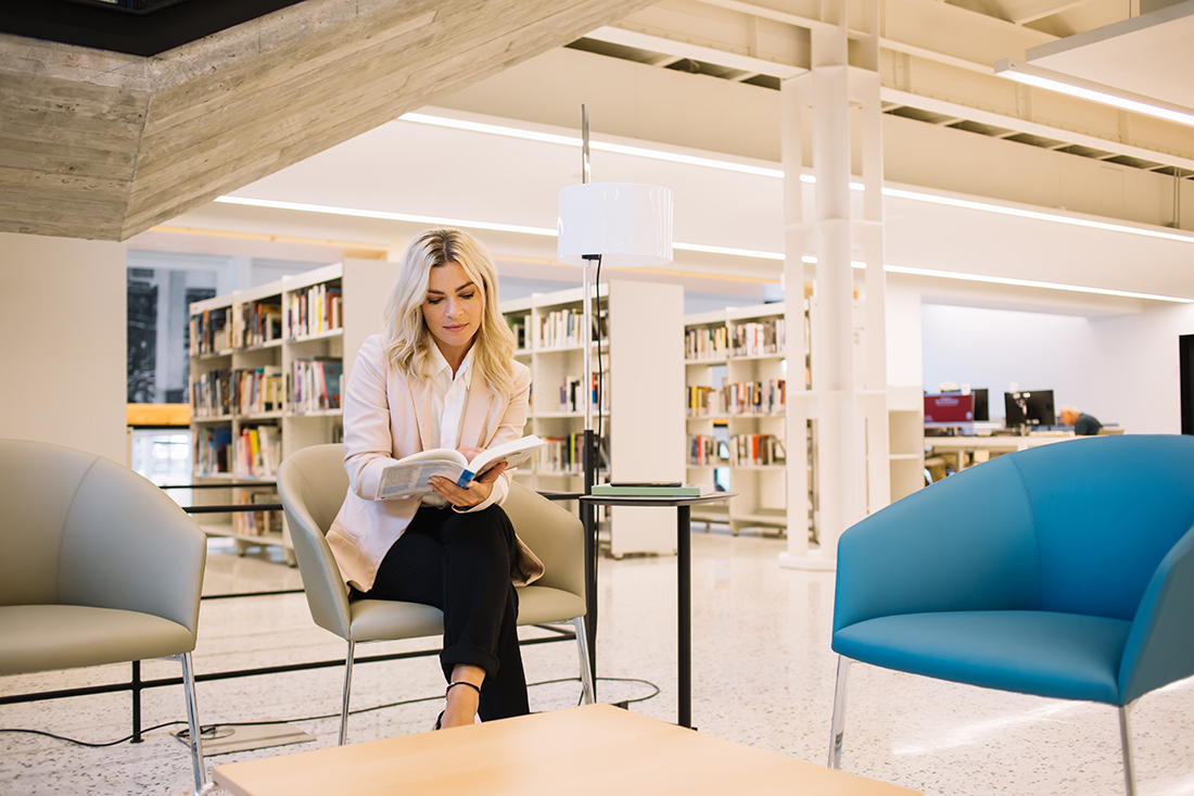 A woman reads a book on leadership