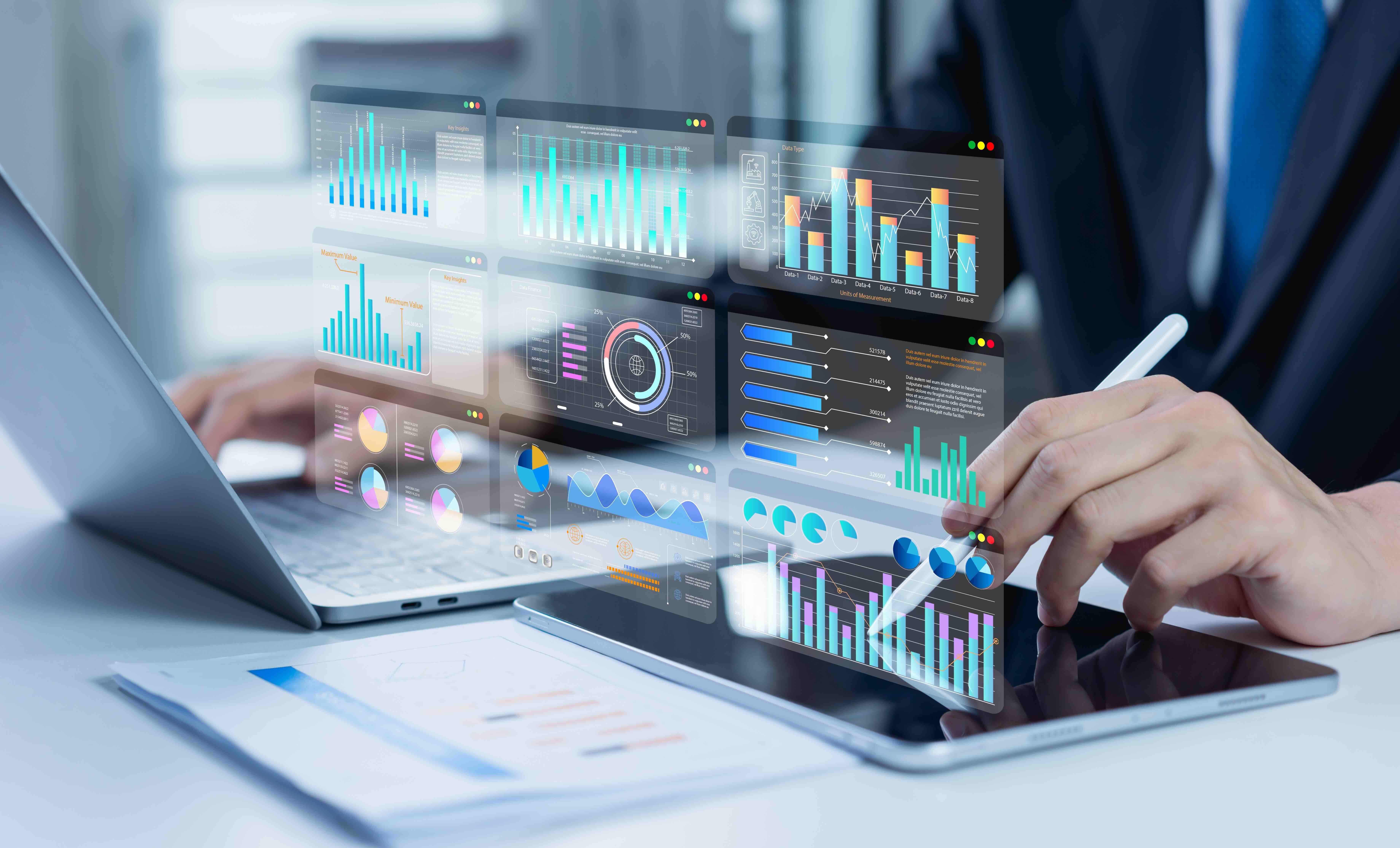 Business professional analyzing multiple data dashboards showing charts, graphs, and financial metrics on digital screens