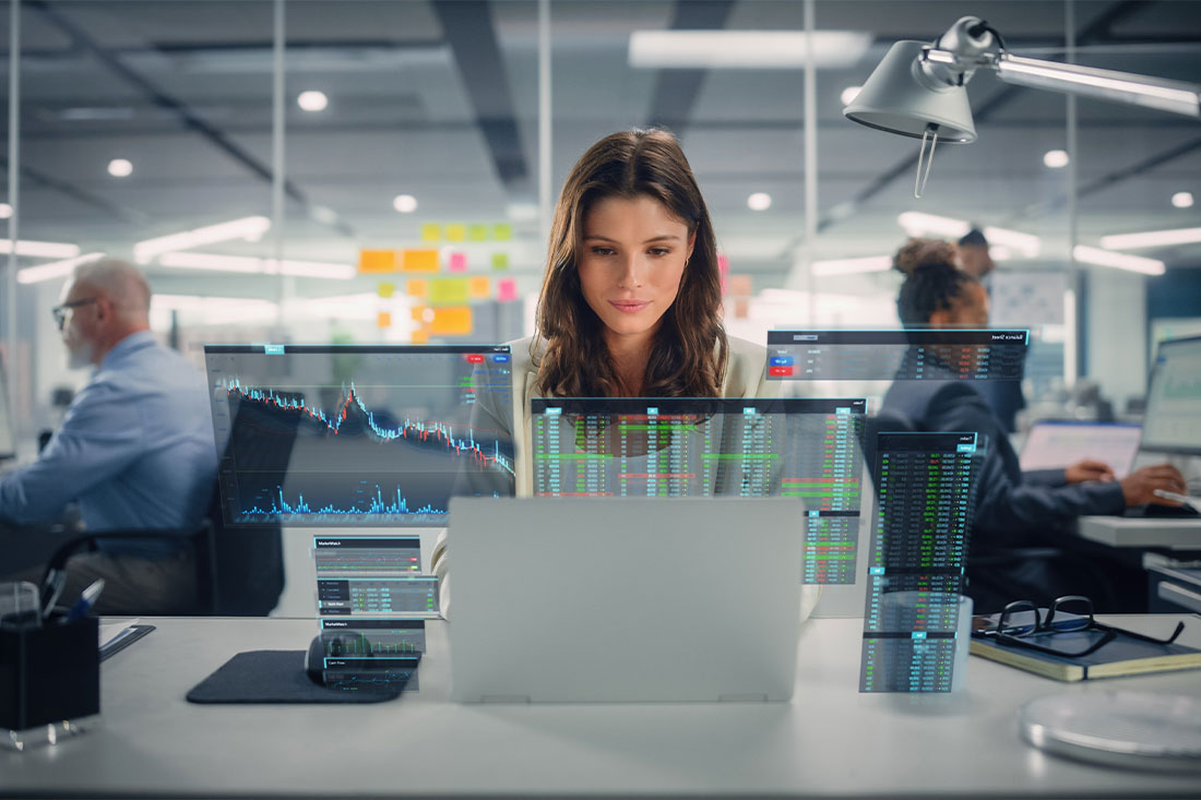 Happy Businesswoman Using Laptop Computer in Modern Office