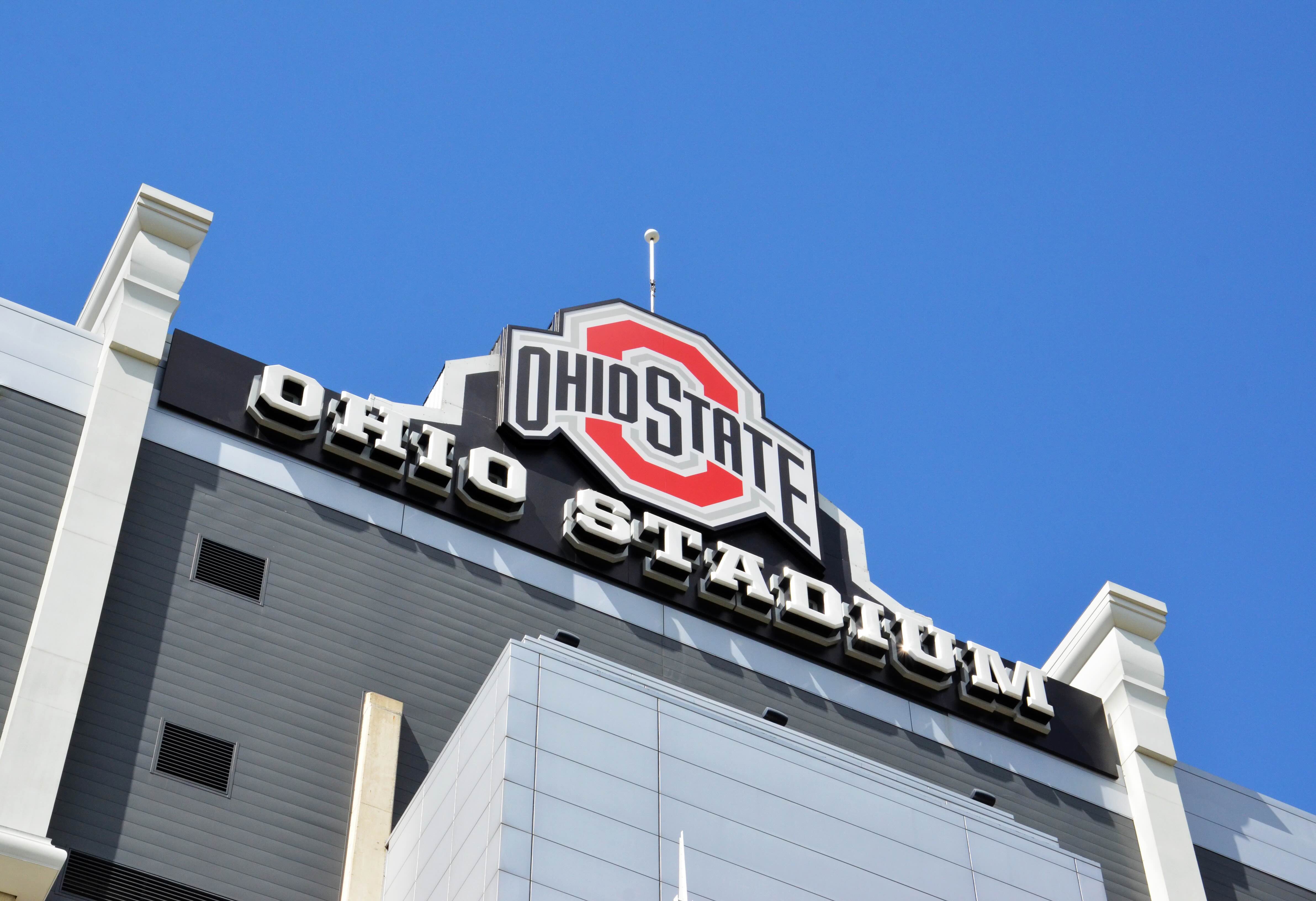 Ohio State Stadium sign with university logo against clear blue sky