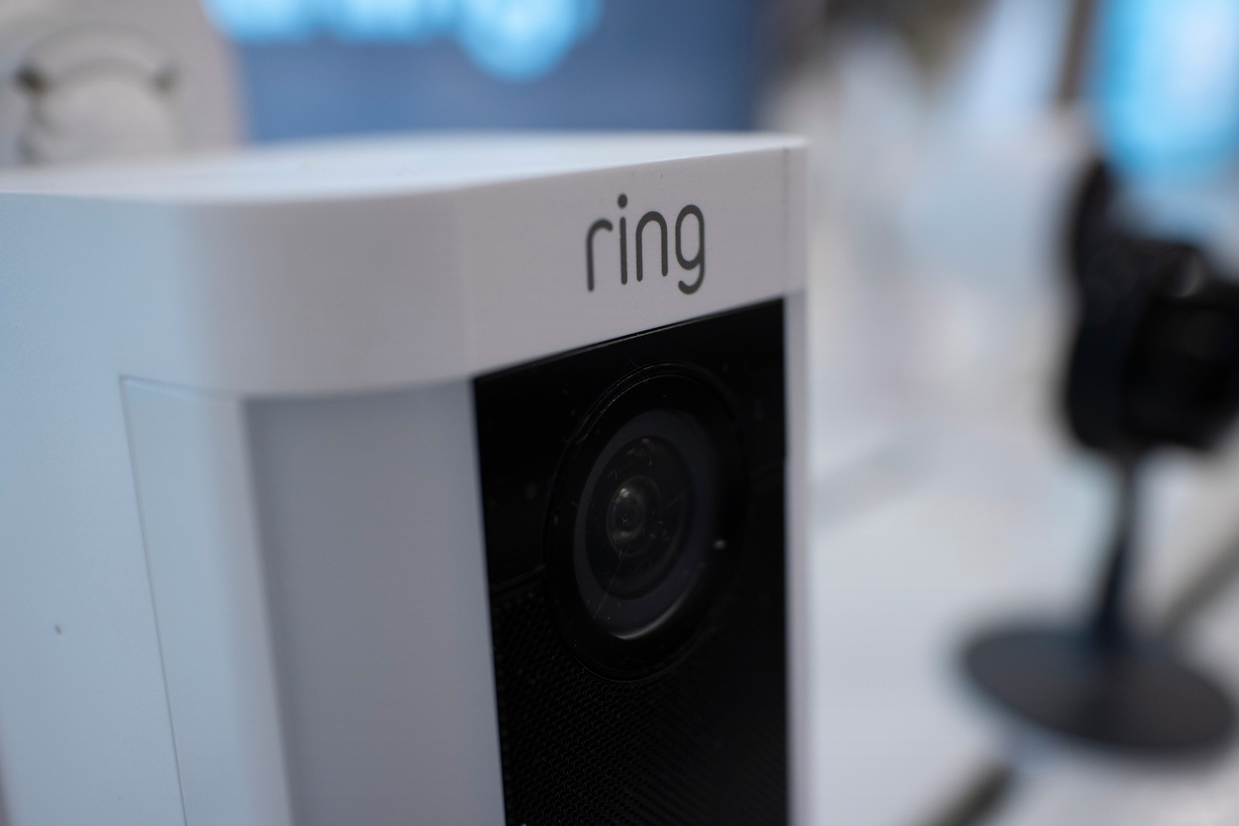 White Ring security camera with black lens mounted indoors