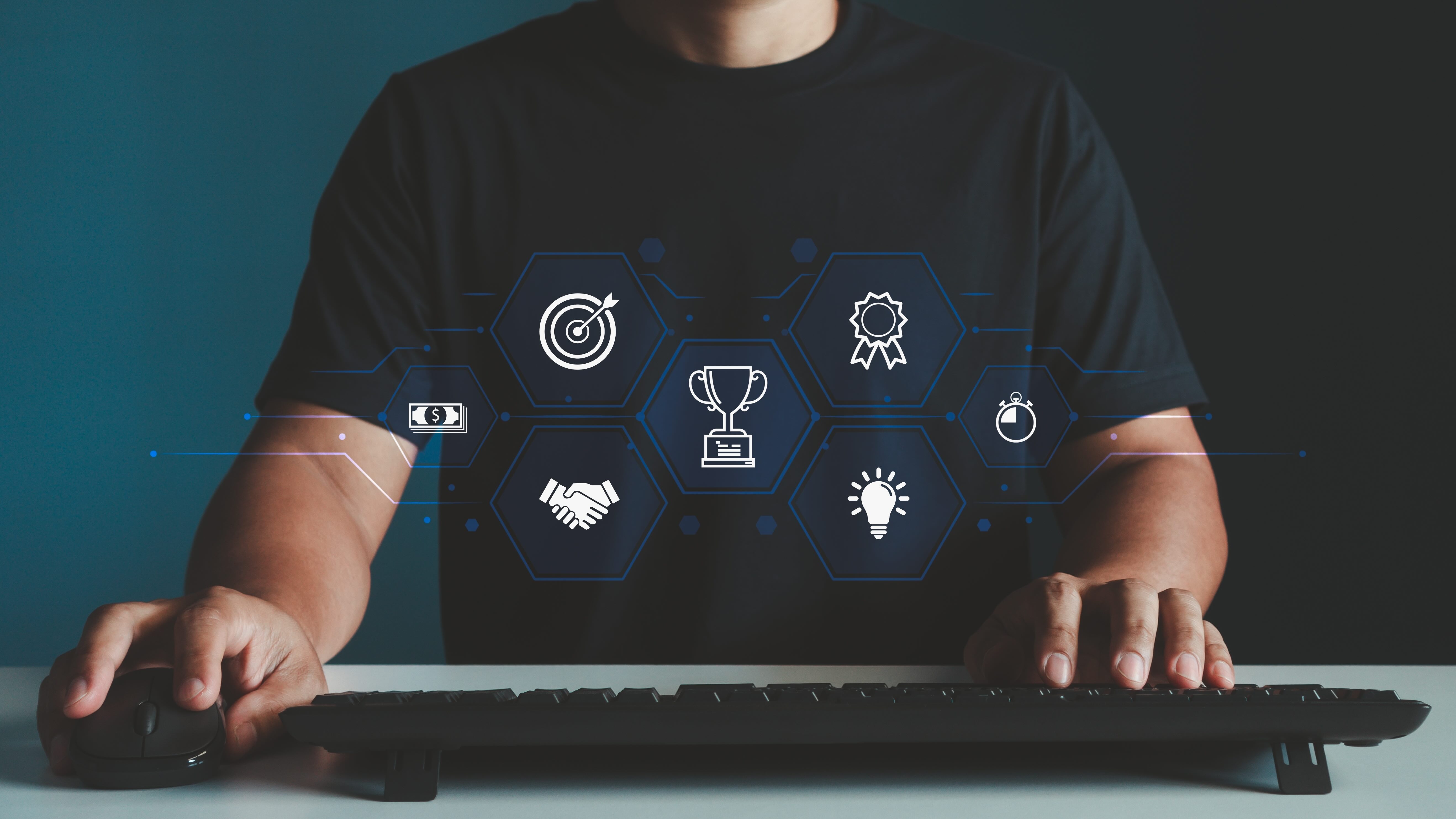 Person at keyboard with digital hexagonal icons showing business concepts like targets, trophies, handshakes, and lightbulbs