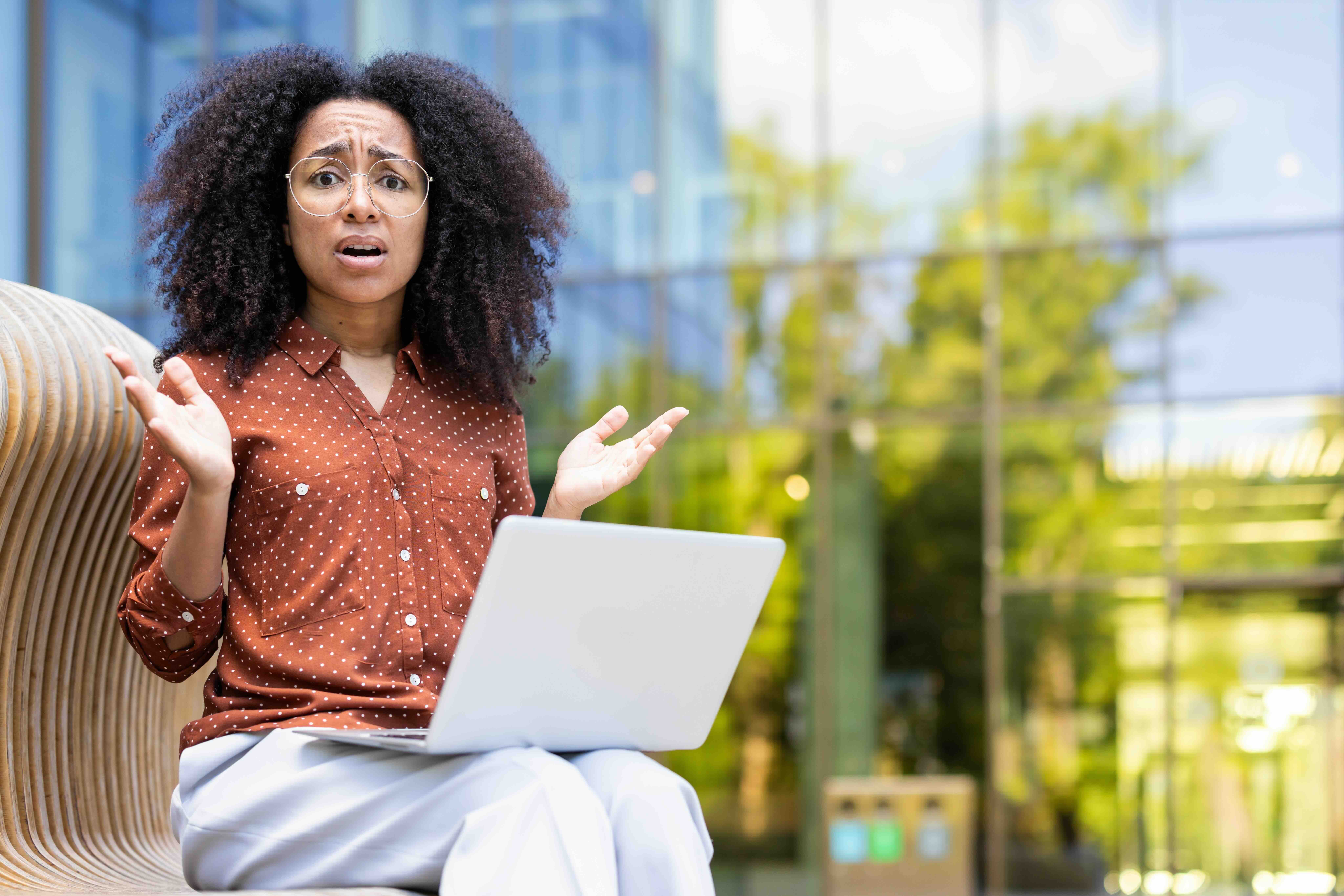 Portrait of anxious and nervous woman with laptop
