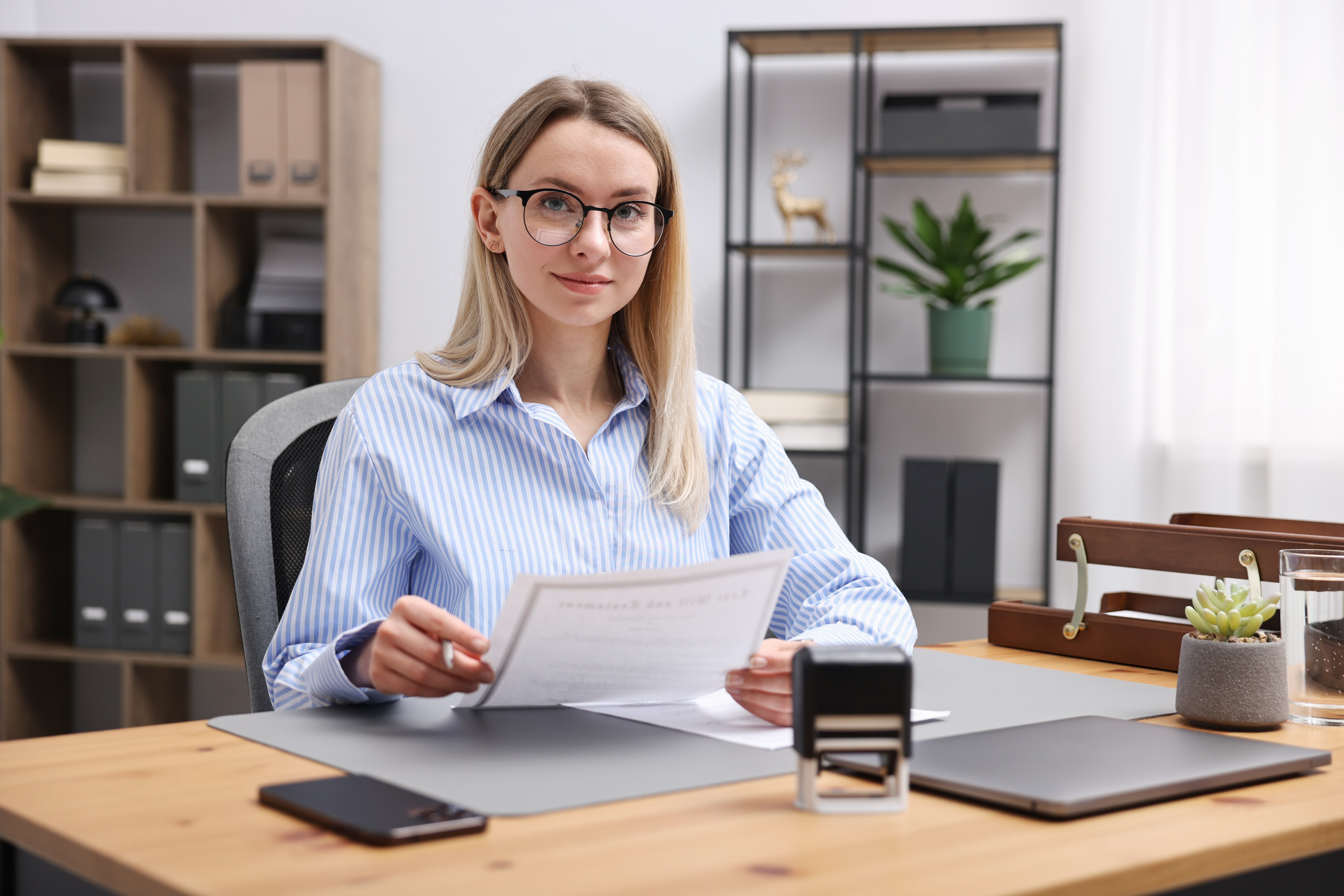 Woman at desk with certificate