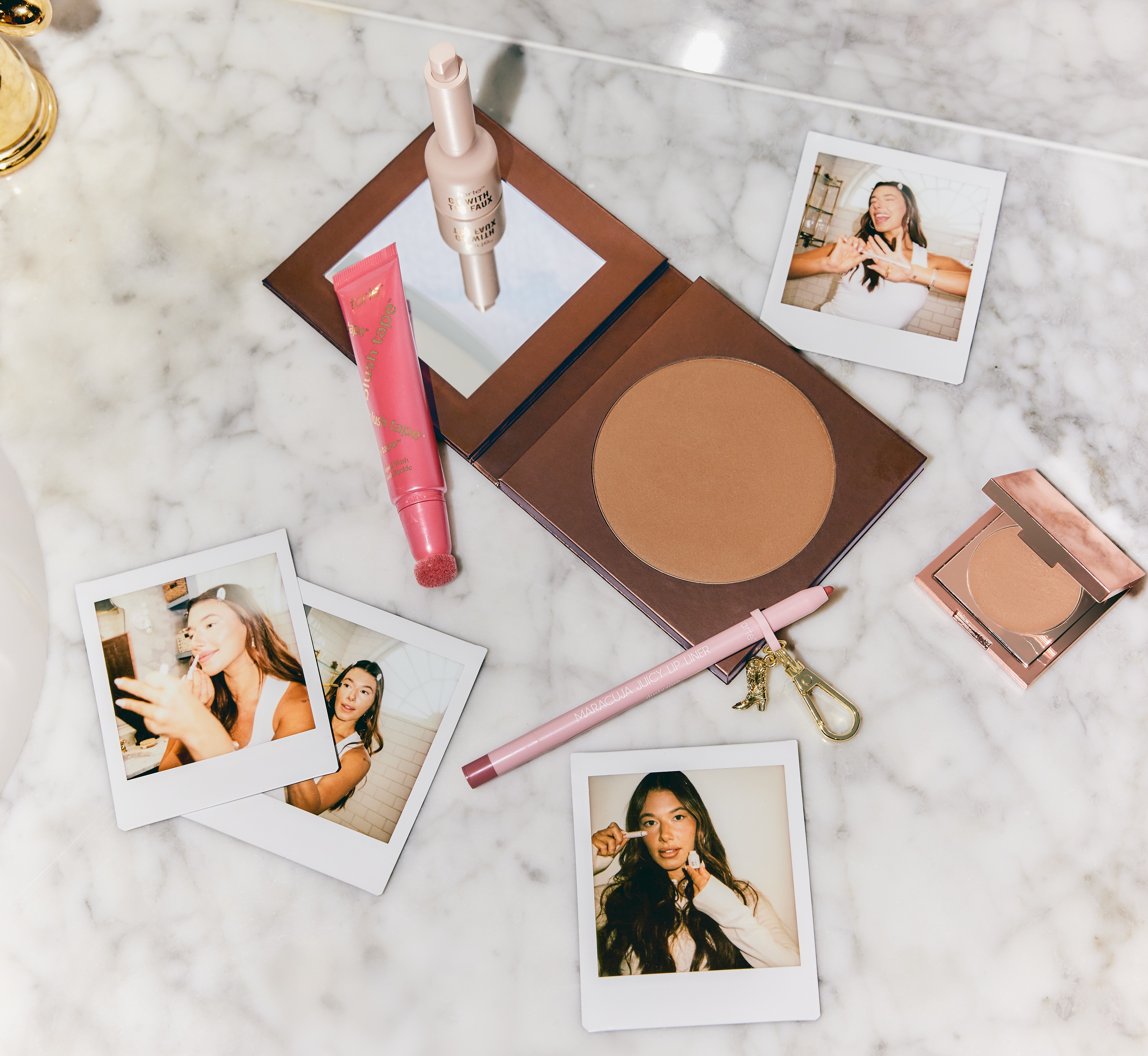 Makeup and polaroid images laying across granite