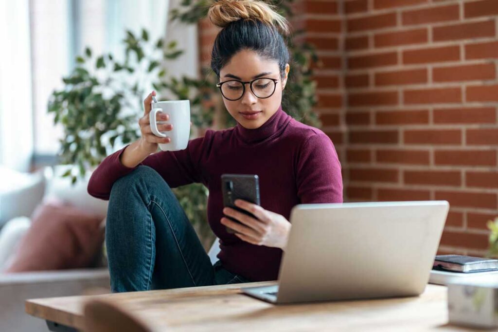 woman working from home distracted by her phone