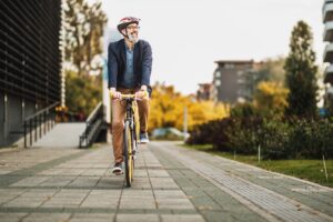 man riding bike to work to help business be more green