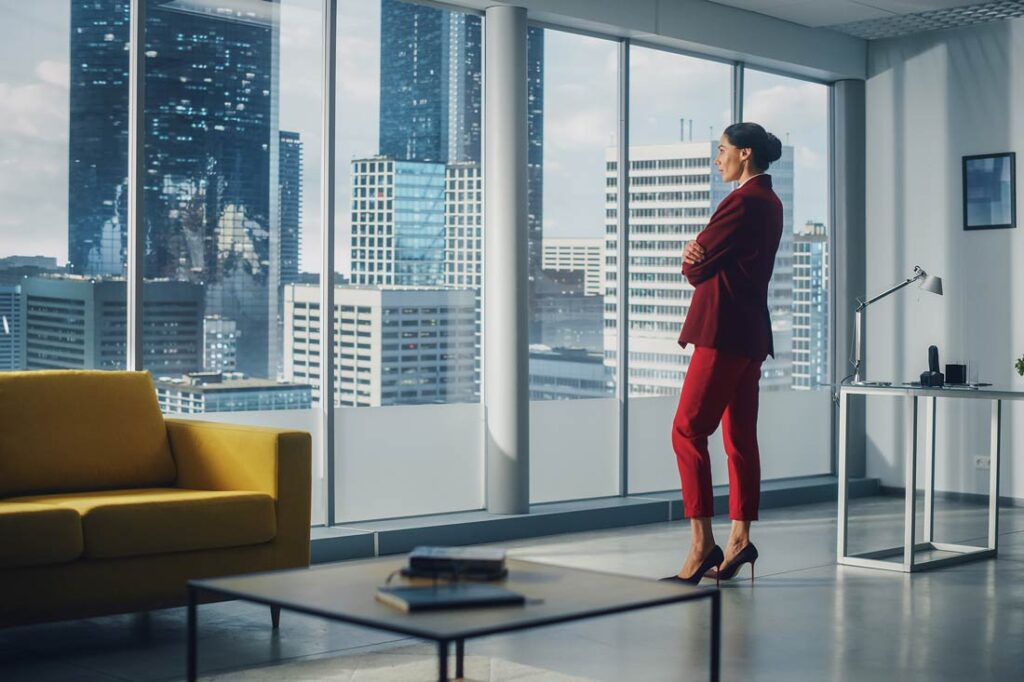 Business women looks out of office window for revolutionary business growth