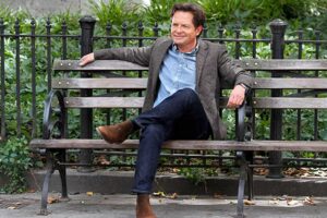 Michael J. Fox sitting on a bench