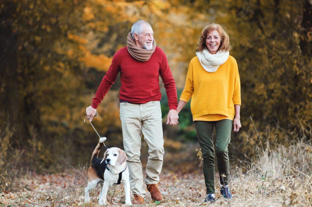 older couple walking outside to nurture well being