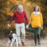 older couple walking outside to nurture well being