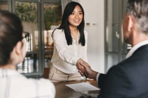 asian woman shaking hands with business investor