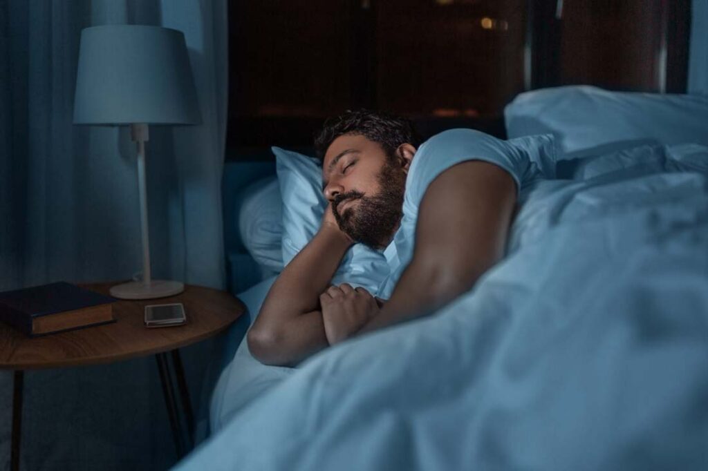 man sleeping in dark room