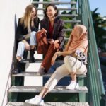 women with charismatic personality talking to friends