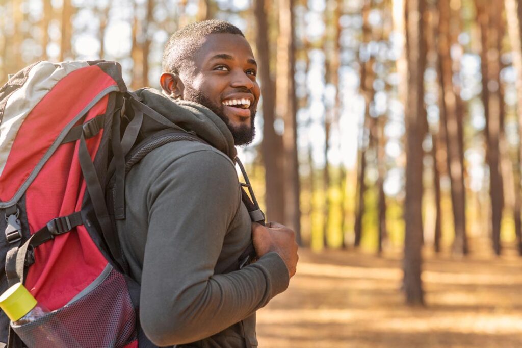 Black man hiking on an autumn day showing how personal development for success works