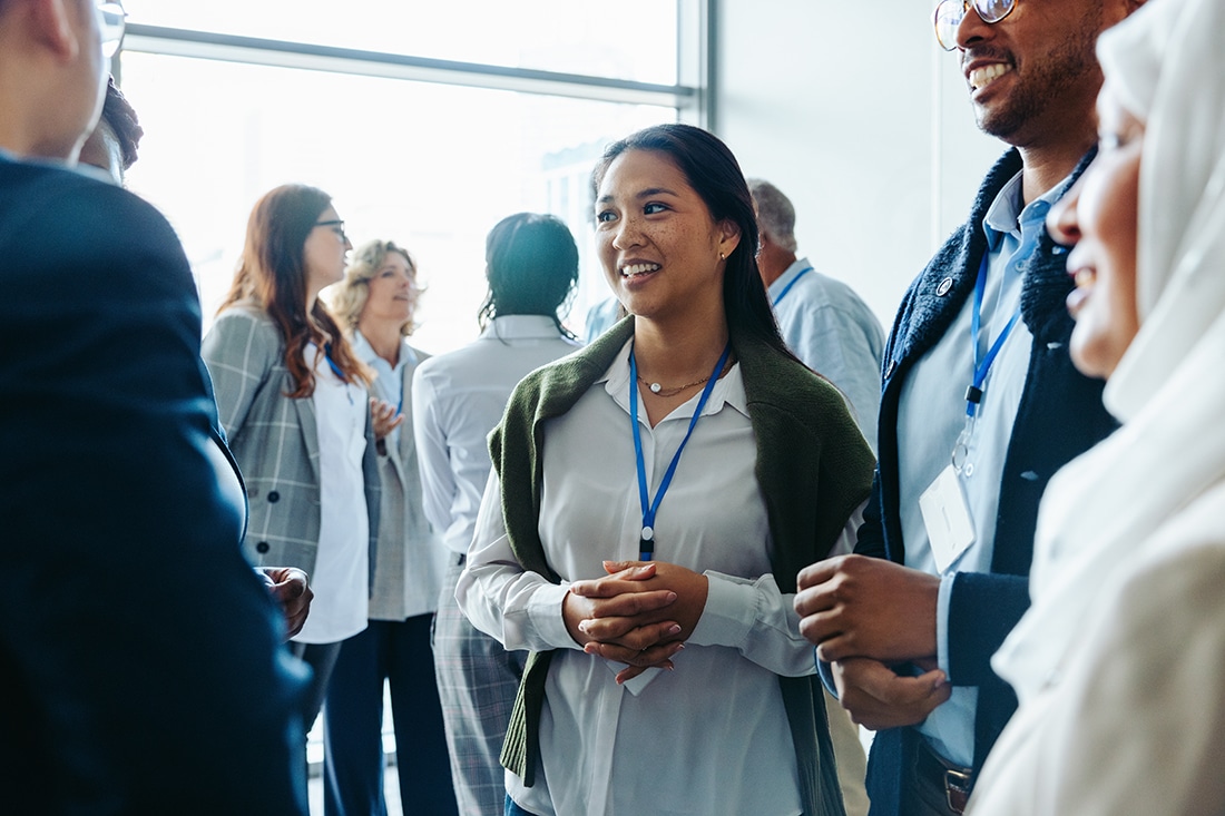 Group of diverse business professionals, businessmen and businesswomen, networking at a conference event.