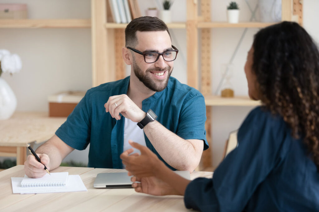 man using tips to speak better in conversation with colleague