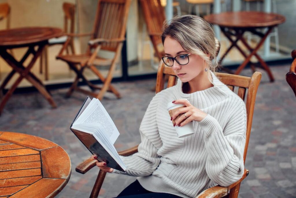 young entrepreneur reading book for inspiration