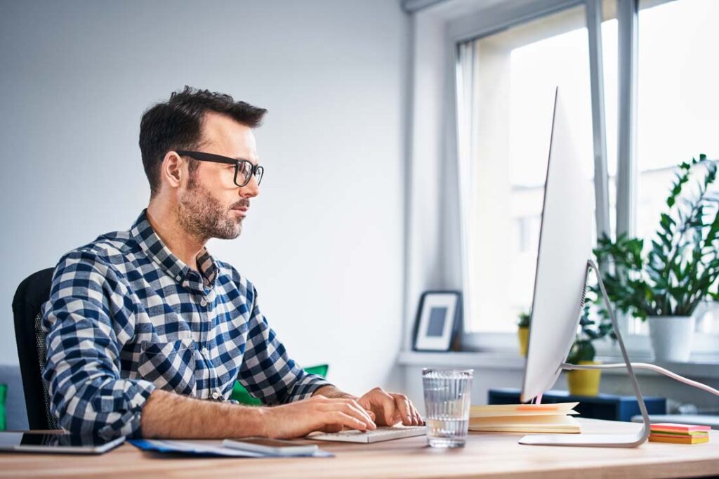 man managing email at computer