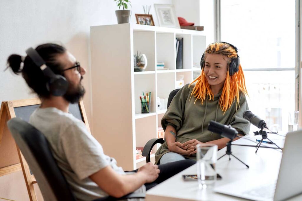 man and woman recording a podcast