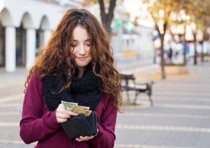 woman pulling money out of wallet