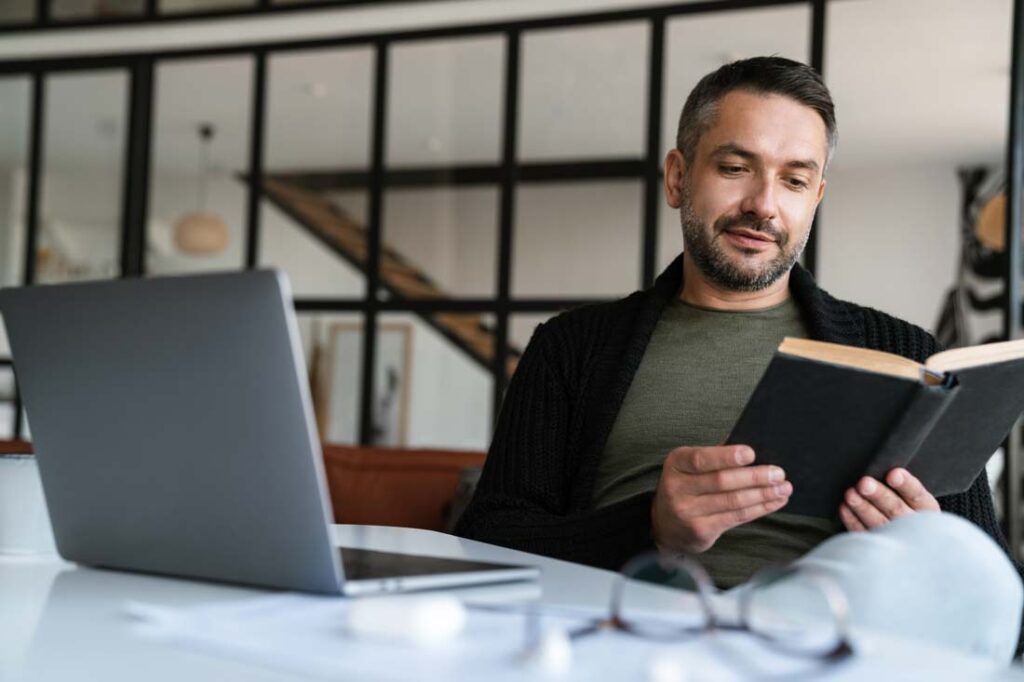 man reading book of poems about success