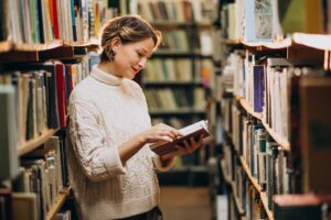 woman browsing books to build her library