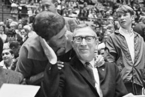 Nellie Riley kissing Coach John Wooden on the cheek