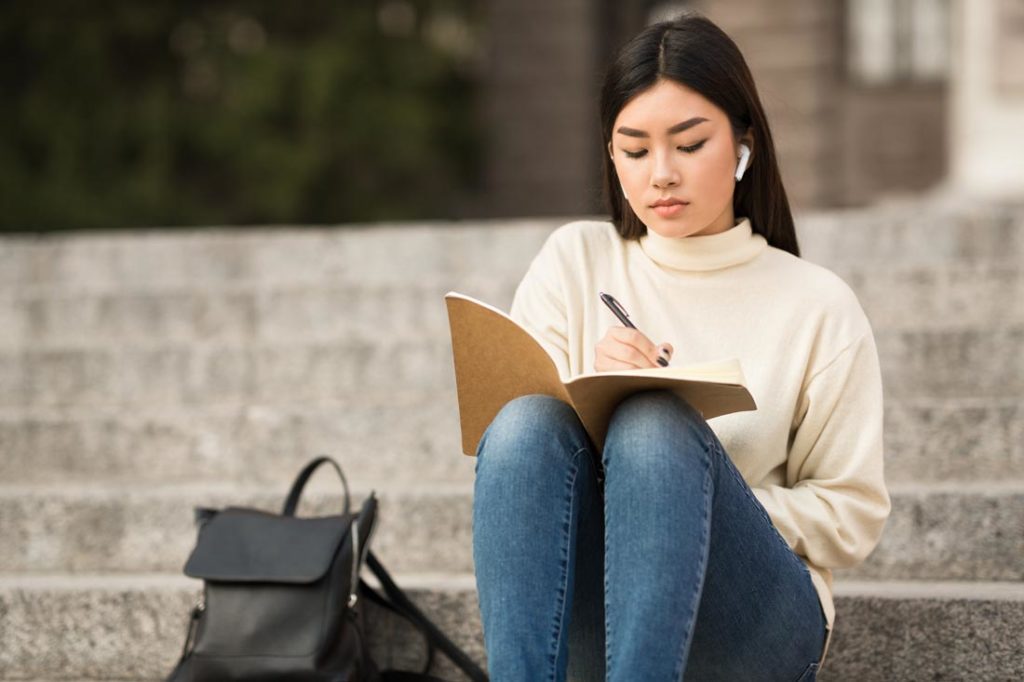 woman writing to-do list in categories