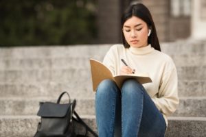 woman writing to-do list in categories