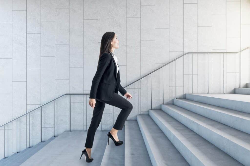 Young business women walking up stairs exemplifying personal growth