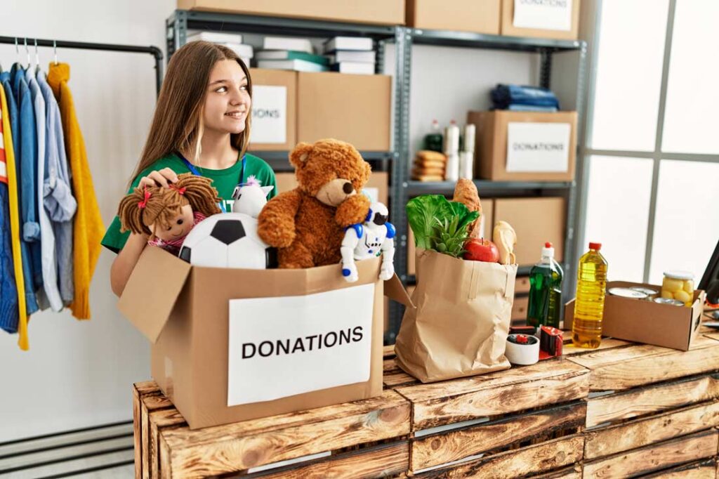 Girl donating her old toys learning about the benefits of gratitude