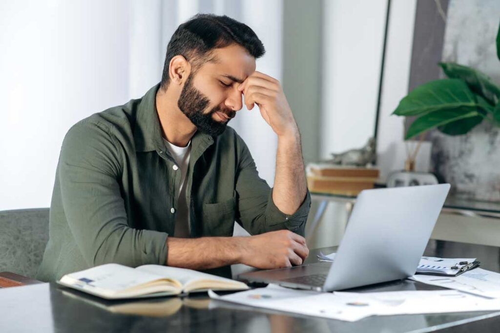 man feeling tired at work