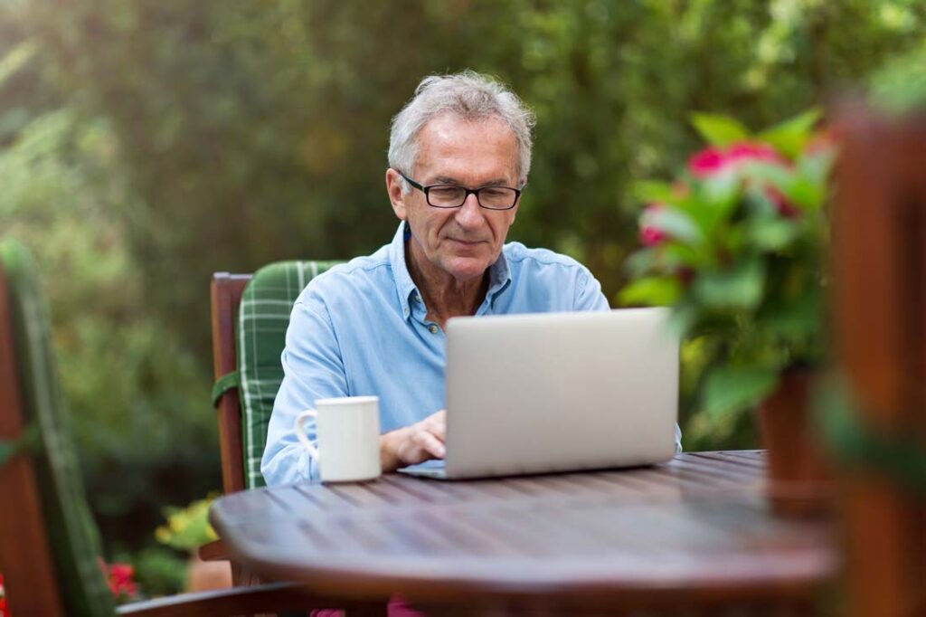 man sitting outside writing to be a better leader