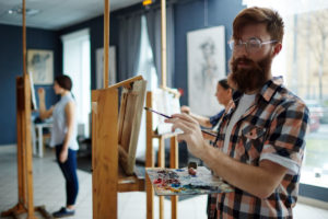 man learning to paint to boost creativity