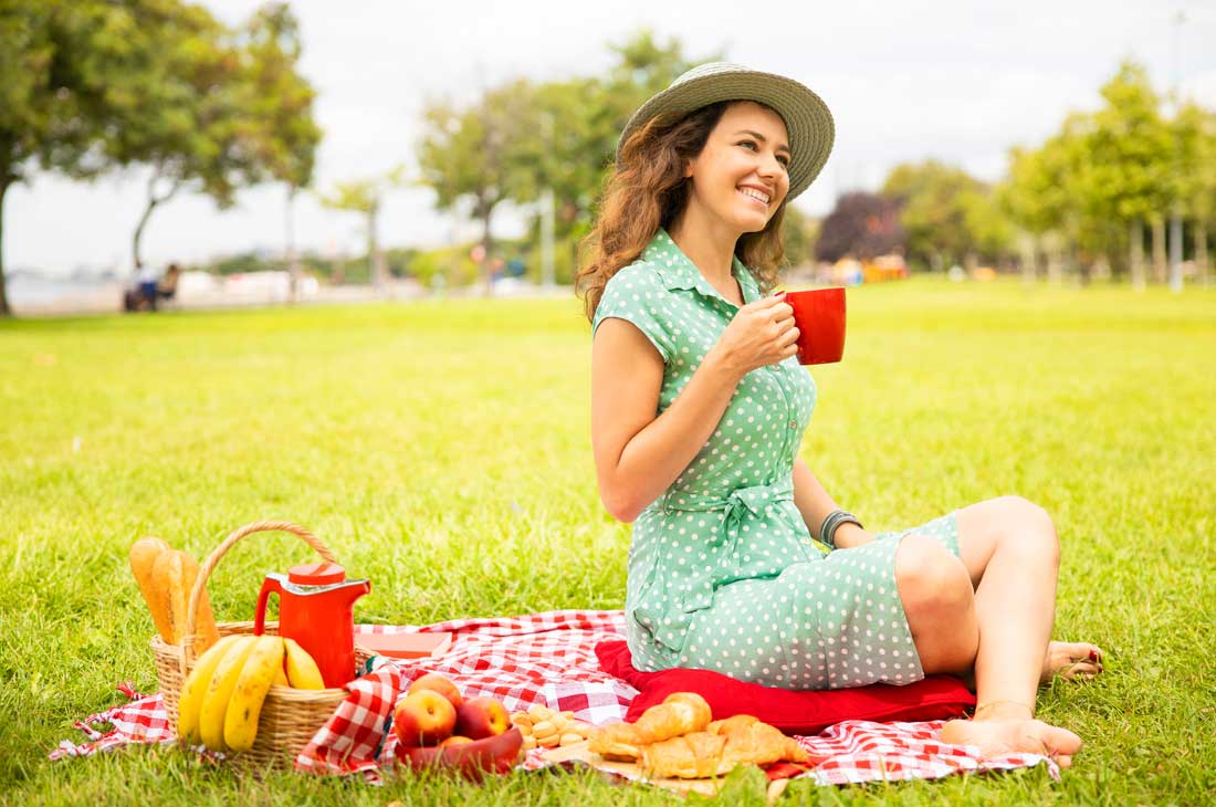 Young women picnic thinking of summertime quotes