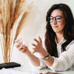 woman crumpling list of stupid new years resolutions