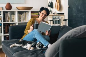 woman reading book for self-improvement