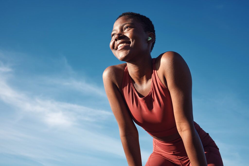 Smiling Black woman resting from exercise learning why personal development is important