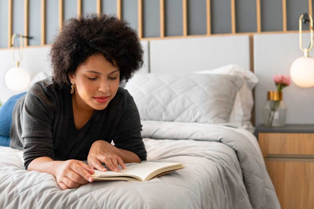 woman reading book by black author