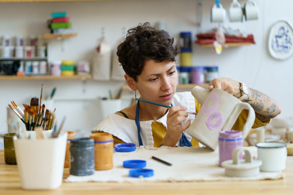 woman focused on making pottery business a profitable side hustle