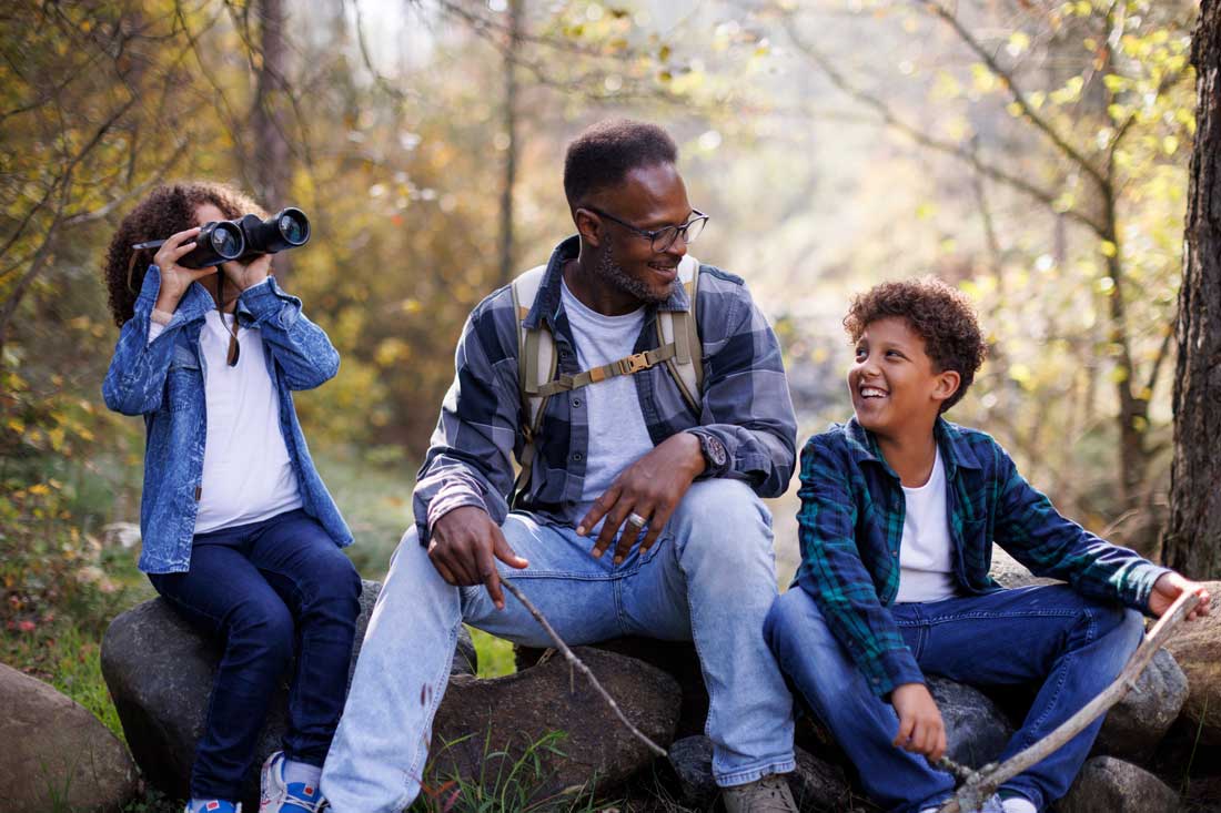Highly successful father hiking with his daughter and son on the weekend