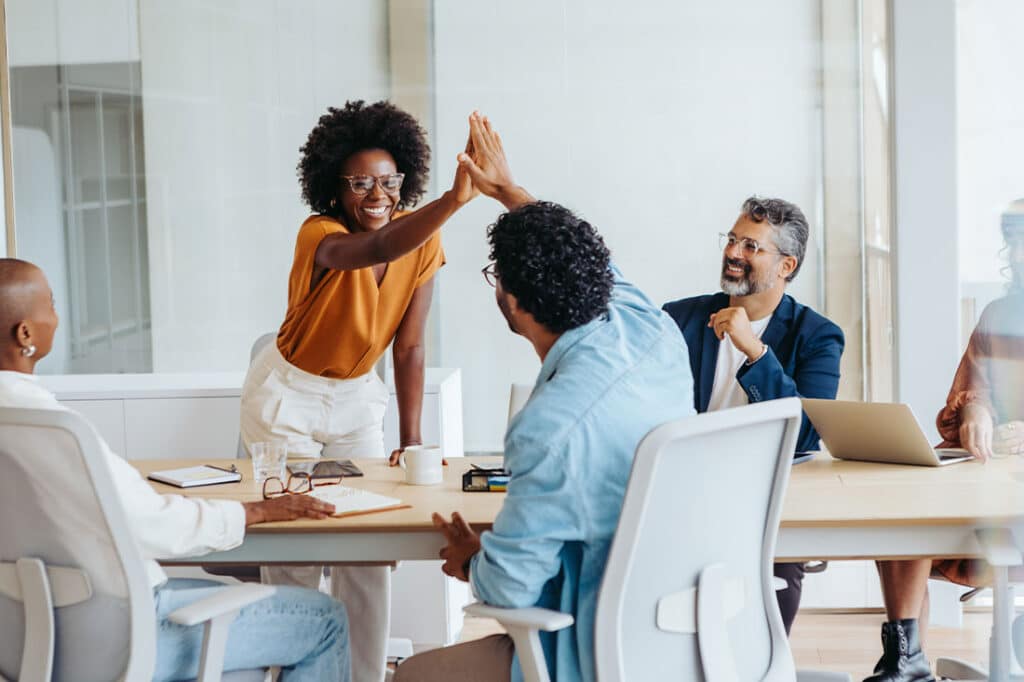Professionals celebrate their achievements with a high five