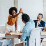 Professionals celebrate their achievements with a high five