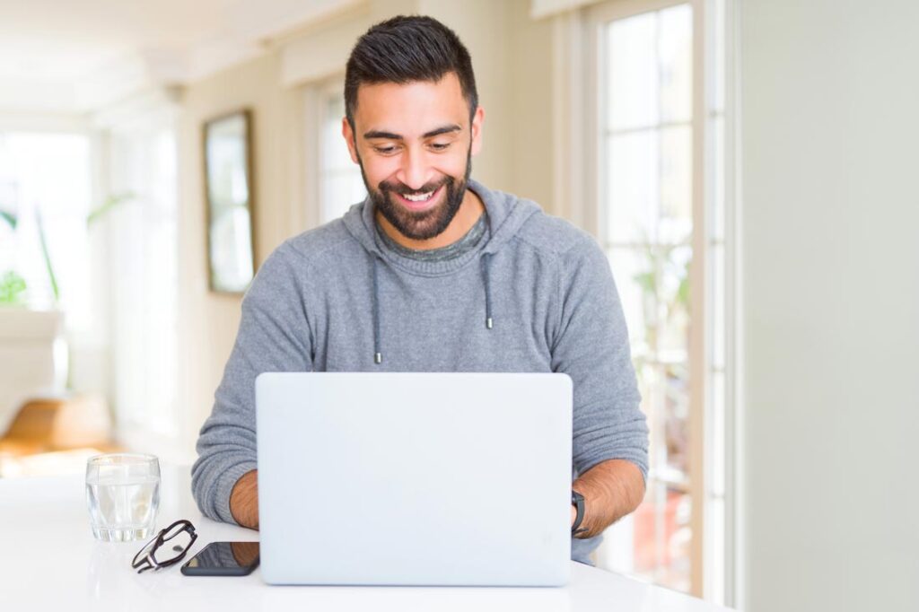 man looking at investments on computer