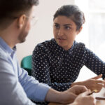 A business coach works with a client on business development goals