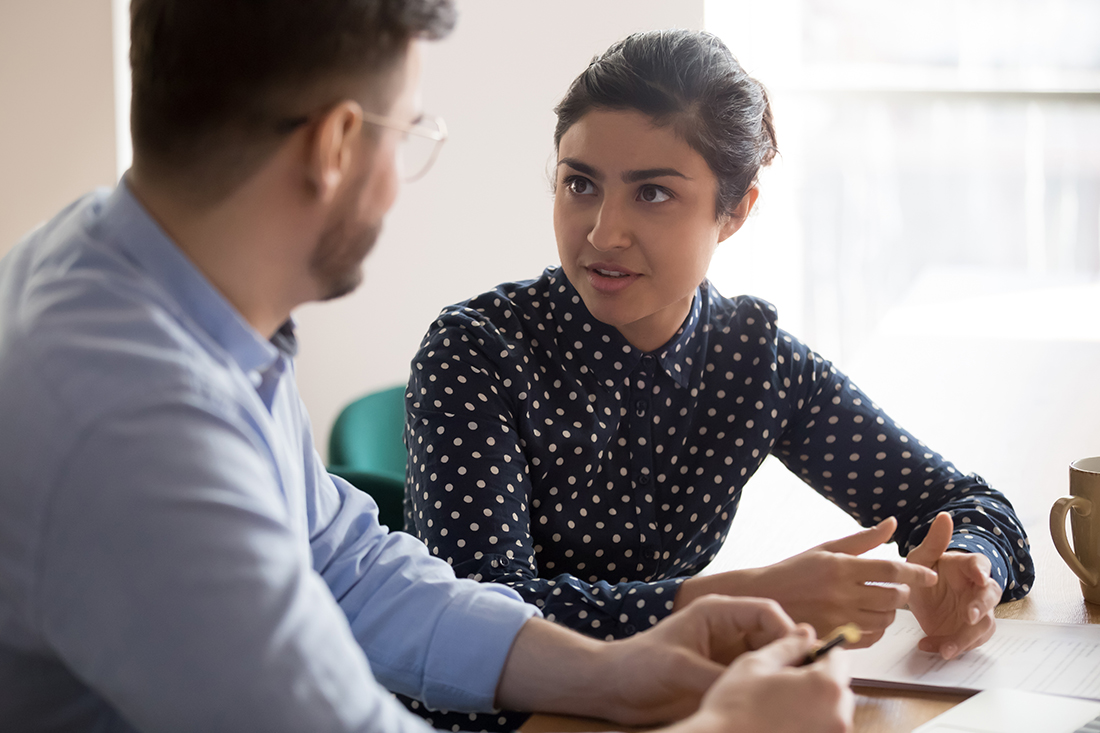 A business coach works with a client on business development goals