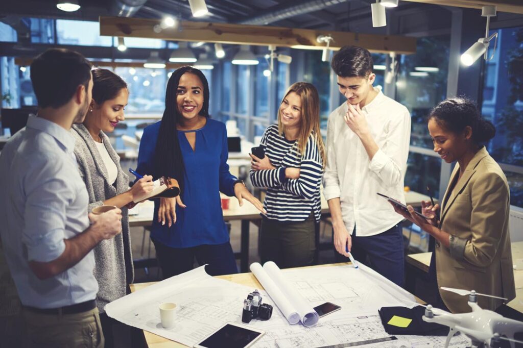 Photograph of a multiethnic group of colleagues discussing something as an example of emotional intelligence