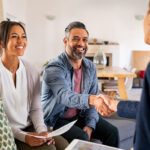 Woman shaking hands with happy clients