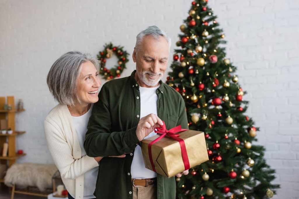 couple opening christmas gifts